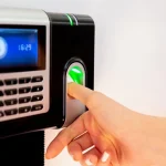 Finger on biometric fingerprint attendance reader.