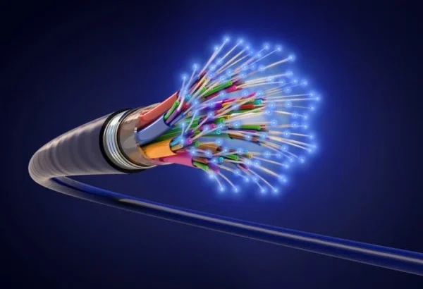 Exposed fiber optic cable with glowing blue strands.