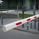 Automated gate barrier with ANPR camera and RFID scanner at a vehicle entry point for access control.