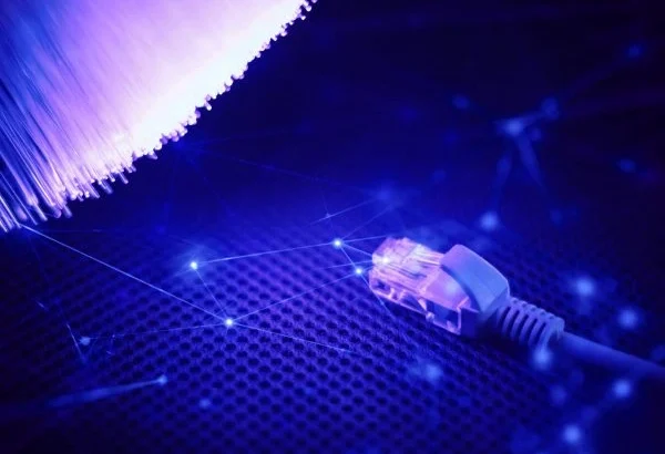Structured cabling with Ethernet connector and glowing fiber optic strands.