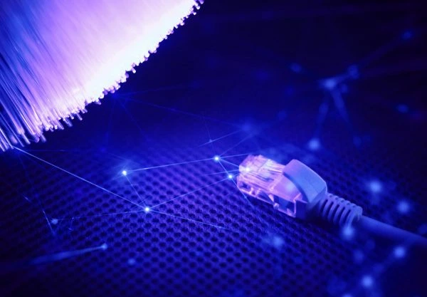 Structured cabling with Ethernet connector and glowing fiber optic strands.