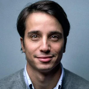 Smiling professional man in grey sweater.