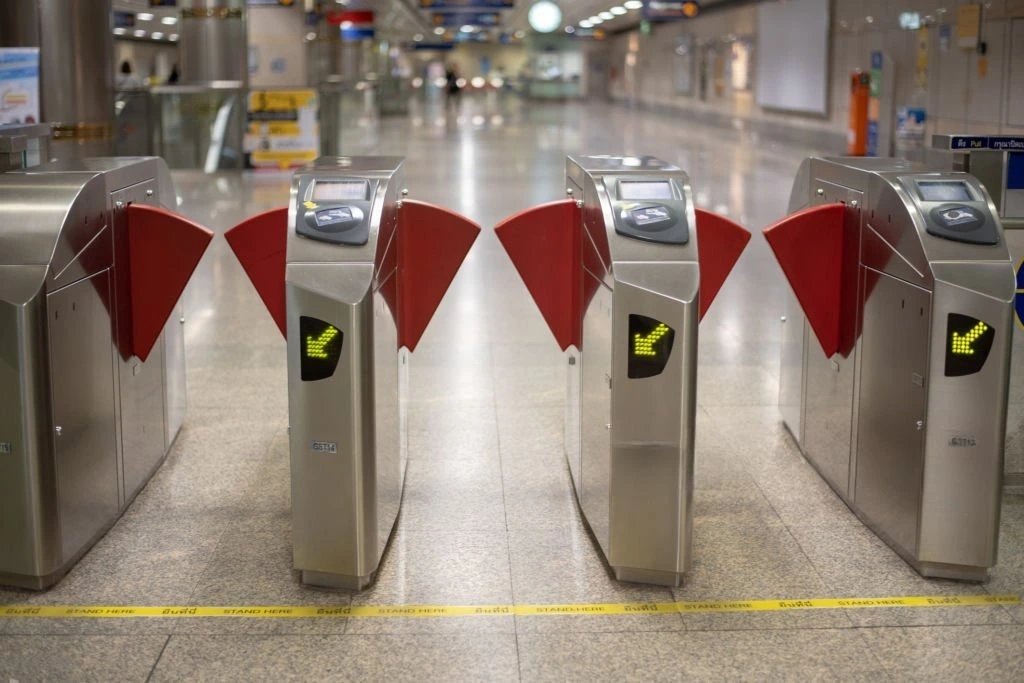 Flap barrier gates used in a modern turnstile access control system in Qatar for high-traffic areas.