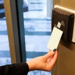 Person scanning RFID card on access control reader
